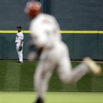Houston Astros center fielder Michael Bourn (21) turns to watch Arizona Diamondbacks' Justin Upton, right, run the bases after trying to catch Upton's home run during the third inning of a baseball game Tuesday, May 4, 2010 in Houston. (AP Photo/David J. Phillip)