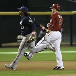 Milwaukee Brewers' Rickie Weeks, left, tags out Arizona Diamondbacks' Stephen Drew after Drew got caught in a run down during the seventh inning of a baseball game Sunday, May 9, 2010, in Phoenix. (AP Photo/Matt York)