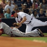Arizona Diamondbacks' Kelly Johnson, left, is tagged out by Atlanta Braves third baseman Chipper Jones while trying to advance on a Justin Upton ground ball in the second inning of a baseball game Friday, May 14, 2010, in Atlanta. (AP Photo/John Bazemore)