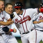 Atlanta Braves' Martin Prado, center, celebrates with teammates Brian McCann, left, and Eric Hinske after driving in the winning run with a two-RBI base hit in the ninth inning of a baseball game against the Arizona Diamondbacks, Friday, May 14, 2010, in Atlanta. (AP Photo/John Bazemore)
