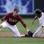 Arizona Diamondbacks shortstop Stephen Drew, left, tags out San Francisco Giants' Nate Schierholtz on a steal attmpt in the third inning of a baseball game Wednesday, May 19, 2010, in Phoenix. (AP Photo/Paul Connors)