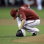 Arizona Diamondbacks pitcher Ian Kennedy falls to his knee after he was hit by a line drive from San Francisco Giants' Aaron Rowand in the third inning of a baseball game Wednesday, May 19, 2010, in Phoenix. Kennedy remained in the game. (AP Photo/Paul Connors)