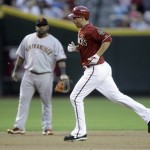 Arizona Diamondbacks' Adam LaRoche, right, trots around the bases in front of San Francisco Giants third baseman Pablo Sandoval after LaRoche hit a solo home run off Giants pitcher Todd Wellemeyer in the second inning of a baseball game Wednesday, May 19, 2010, in Phoenix. (AP Photo/Paul Connors)
