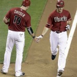 Arizona Diamondbacks' Kelly Johnson, right, is congratulated by teammate Chris Snyder as Johnson approaches home after hitting a two-run home run against the San Francisco Giants in the eighth inning of a baseball game Wednesday, May 19, 2010, in Phoenix. The Diamondbacks scored six runs in the inning, tying a team record. (AP Photo/Paul Connors)