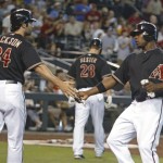 Arizona Diamondbacks' Justin Upton, right, is congratulated by Conor Jackson after they scored on Chris Young's single against the Toronto Blue Jays during the second inning of an interleague baseball game Saturday, May 22, 2010 in Phoenix. (AP Photo/Ralph Freso)