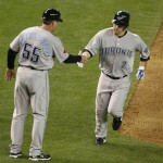 Toronto Blue Jays' Aaron Hill, right, is congratulated by third base coach Brian Butterfield following his solo home run against the Arizona Diamondbacks during the eighth inning of an interleague baseball game Saturday, May 22, 2010, in Phoenix. (AP Photo/Ralph Freso)