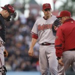 Arizona Diamondbacks' Billy Buckner, center, waits to speak with pitching coach Mel Stottlemyre, right, during the fifth inning of a baseball game against the San Francisco Giants Saturday, May 29, 2010, in San Francisco. At left is Diamondbacks catcher Chris Snyder. (AP Photo/Ben Margot)