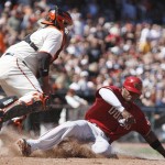 Arizona Diamondbacks' Justin Upton, right, slides to score beneath San Francisco Giants catcher Bengie Molina during the eighth inning of a baseball game Sunday, May 30, 2010, in San Francisco. Upton scored on a sacrifice fly hit by Chris Young. (AP Photo/Ben Margot)