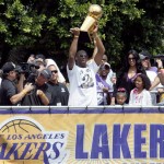 Los Angeles Lakers' Kobe Bryant holds the NBA championship trophy aloft during the basketball team's victory parade in Los Angeles, Monday, June 21, 2010. The Lakers defeated the Boston Celtics for the title, four games to two. (AP Photo/Nick Ut)