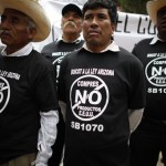 Protesters attend a demonstration against Arizona's new immigration law outside the US embassy in Mexico City, Wednesday July 28, 2010. Their T-shirts read in Spanish "Boycott Arizona's law, don't buy US products." (AP Photo/Alexandre Meneghini)