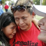 From left to right, Joseline Saragoza, 9, and Marcela Saragoza, cry as Nora Nendivin smiles as they celebrate at the Arizona capitol Wednesday, July 28, 2010 in Phoenix, shortly after portions of Arizona's new immigration law, SB1070, were blocked by a federal judge. The judge has blocked the most controversial sections of Arizona's new immigration law from taking effect Thursday, handing a major legal victory to opponents of the crackdown. The law will still take effect Thursday, but without many of the provisions that angered opponents, including sections that required officers to check a person's immigration status while enforcing other laws. The judge also put on hold a part of the law that required immigrants to carry their papers at all times, and made it illegal for undocumented workers to solicit employment in public places. (AP Photo/Ross D. Franklin)