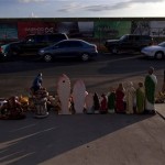  A street vendor lines up his goods along a street as cars line-up to cross to the U.S. near the port of entry in San Luis Rio Colorado, Mexico, on the other side of the border from the U.S. city of Yuma, Arizona, Thursday July 29, 2010. A US federal judge blocked on Wednesday the most controversial parts of Arizona's immigration law from taking effect. The overall law will still take effect Thursday but without the provisions that angered opponents, including sections that required immigrants to carry their papers and law officers to check on a person's immigration status while enforcing other laws. (AP Photo/Guillermo Arias)