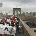 A coalition of immigrant groups and their supporters march in the hundreds across the Brooklyn Bridge, Thursday July 29, 2010, in New York. Protesters are calling for the full repeal of Arizona's immigration law, saying it fuels a climate of racism. (AP Photo/Bebeto Matthews)