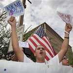 Angel Sanchez, of Tucson, protests Thursday, July 29, 2010 in Phoenix against Arizona's controversial immigration law, SB1070. Opponents of Arizona's immigration crackdown went ahead with protests Thursday despite a judge's ruling that delayed enforcement of most the law. (AP Photo/Matt York)