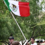 Daniel Carrillo, of Los Angeles, waves a Mexican flag during protests Thursday, July 29, 2010 in Phoenix against Arizona's new immigration law, SB1070. Opponents of Arizona's immigration crackdown went ahead with protests Thursday despite a judge's ruling that delayed enforcement of most the law. (AP Photo/Matt York)	

