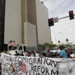 Protesters gather Thursday, July 29, 2010 in Phoenix to rally against Arizona's new immigration law, SB1070. Opponents of Arizona's immigration crackdown went ahead with protests Thursday despite a judge's ruling that delayed enforcement of most the law. (AP Photo/Matt York)