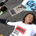 Two protestors who declined to give their names chained themselves together with others at the intersection of Wilshire and Highland in Los Angeles on Thursday, July 29, 2010 in protest Arizona immigration law SB 1070. (AP Photo/Adam Lau)