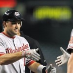 Washington Nationals' Ryan Zimmerman, left, celebrates his home run against the Arizona Diamondbacks with a handshake from Adam Dunn during the first inning of a baseball game Tuesday, Aug. 3, 2010, in Phoenix. (AP Photo/Ross D. Franklin)