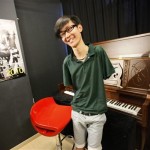 In this Aug. 26, 2010 photo, pianist Liu Wei who plays the piano with his toes smiles after his practice session in Shanghai. Liu's arms were amputated from the shoulders at age 10 after he was electrocuted while playing hide-and-seek with his friends and is now appearing in Chinese talent show Dragon TV's "China's Got Talent." (AP Photo/Eugene Hoshiko)
