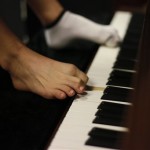 In this Aug. 26, 2010 photo, pianist Liu Wei plays the piano with his toes during his practice session in Shanghai. Liu's arms were amputated from the shoulders at age 10 after he was electrocuted while playing hide-and-seek with his friends and is now appearing in Chinese talent show Dragon TV's "China's Got Talent." (AP Photo/Eugene Hoshiko)
