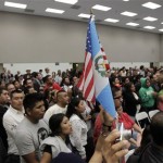 A man holds up an American flag and a Guatemalan flag during a community meeting in Los Angeles, Wednesday, Sept. 8, 2010. Police Chief Charlie Beck was greeted by boos, whistles and chants of "justicia" by an angry Spanish-speaking crowd at a community meeting Wednesday intended to quell violence that erupted over the past two nights after police fatally shot a knife-wielding man. A crowd of about 300 packed a school in the Westlake neighborhood where Manuel Jamines, 37, was shot to death Sunday by an officer after he allegedly lunged toward the officer with a knife. (AP Photo/Jae C. Hong)