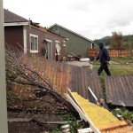 A man walks through a Bellemont, Ariz., backyard after a tornado swept through the community west of Flagstaff on Wednesday, Oct. 6. (AP Photo/Felicia Fonseca)
