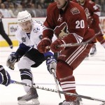 Phoenix Coyotes' Eric Belanger (20) battles with Tampa Bay Lightning's Steven Stamkos (91) in the second period in an NHL hockey game Saturday, Oct. 30, 2010, in Glendale, Ariz. (AP Photo/Ross D. Franklin)