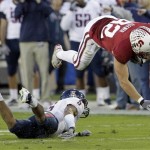 Stanford tight end Coby Fleener (82) dives over Arizona cornerback Shaquille Richardson (5) in the second quarter of an NCAA college football game in Stanford, Calif., Saturday, Nov. 6, 2010. (AP Photo/Paul Sakuma)