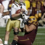 UCLA quarterback Richard Brehaut, left, is sacked by Arizona State defensive lineman Lawrence Guy, right, in the second quarter of an NCAA football game, Friday, Nov. 26, 2010, in Tempe, Ariz. (AP Photo/Paul Connors)