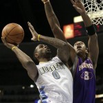 Denver Nuggets forward Gary Forbes (0) scores past Phoenix Suns center Channing Frye (8) during the first quarter of an NBA basketball game in Denver, Sunday, Nov. 28, 2010. (AP Photo/Barry Gutierrez)