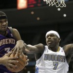 As Phoenix Suns forward Jared Dudley (3) goes to the hoop, Denver Nuggets forward Al Harrington (7) gets a hand on the ball during the fourth quarter of an NBA basketball game in Denver, Nov. 28, 2010. Nuggets won 138-133. (AP Photo/Barry Gutierrez)