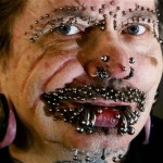 German Rolf Buchholz shows his face with 168 piercings as he visits the 20th Tattoo Convention in Berlin on Saturday, Dec. 4, 2010. About 200 tattoo artists and around 300 exhibitors show their work at one of the greatest European Tattoo shows at the German capital. (AP Photo/Markus Schreiber)