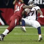 Denver Broncos running back Knowshon Moreno, right, is tackled by Arizona Cardinals safety Adrian Wilson, left, during the second quarter of an NFL football game Sunday, Dec. 12, 2010, in Glendale, Ariz. (AP Photo/Paul Connors)