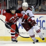New Jersey Devils' Patrik Elias, left, of the Czech Republic, battles for control of the puck with Phoenix Coyotes' Scottie Upshall during the first period of an NHL hockey game Wednesday, Dec. 15, 2010 in Newark, N.J. (AP Photo/Bill Kostroun)