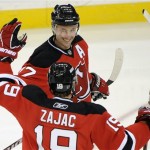 New Jersey Devils' Ilya Kovalchuk, top, celebrates his goal with teammate Travis Zajac (19) during the third period of an NHL hockey game against the Phoenix Coyotes, Wednesday, Dec. 15, 2010, in Newark, N.J. Kovalchuk scored two goals as the Devils defeated the Coyotes 3-0. (AP Photo/Bill Kostroun)