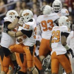 Oklahoma State players celebrate after a fumble recovery during the first quarter of the Alamo Bowl NCAA college football game against Arizona, Wednesday, Dec. 29, 2010, in San Antonio. (AP Photo/Eric Gay)