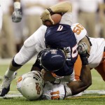 Arizona's Nick Foles (8) is sacked by Oklahoma State's Ugo Chinasa (91) and Jamie Blatnick (50)during the first quarter of the Alamo Bowl NCAA college football game, Wednesday, Dec. 29, 2010, in San Antonio. (AP Photo/Eric Gay)