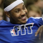 Denver Nuggets small forward Carmelo Anthony (15) smiles on the bench while chatting with teammates as they play the Phoenix Suns in the first half of an NBA basketball game in Denver Tuesday, Jan. 11, 2011. (AP Photo/Barry Gutierrez)