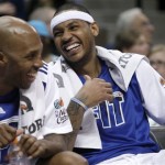 Denver Nuggets' Chauncey Billups, left, and Carmelo Anthony smile on the bench during the fourth quarter of the Nuggets' 132-98 win over the Phoenix Suns in an NBA basketball game in Denver on Tuesday, Jan. 11, 2011. (AP Photo/Barry Gutierrez)