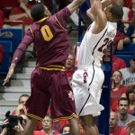 Arizona's Derrick Williams (23) shoots for two over the defense of Arizona States' Carrick Felix (0) during the second half of an NCAA college basketball game at McKale Center in Tucson, Ariz., Saturday, Jan. 15, 2011. Arizona 80-69. (AP Photo/John Miller)