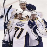 Nashville Predators' J.P. Dumont (71) celebrates his goal with teammates after his goal against the Phoenix Coyotes during the first period of an NHL hockey game Tuesday, Jan. 18, 2011, in Glendale, Ariz. (AP Photo/Matt York)