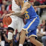 UCLA's Tyler Honeycutt (23) tries to dribble around Arizona's Derrick Williams (23) during the first half of an NCAA college basketball game at McKale Center in Tucson, Ariz., Thursday, Jan. 27, 2011. (AP Photo/John Miller)