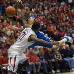 UCLA's Tyler Honeycutt, top, tries to drive to the basket around Arizona's Kyle Fogg (21) in the first half of an NCAA college basketball game at McKale Center in Tucson, Ariz., Thursday, Jan. 27, 2011. (AP Photo/Wily Low)