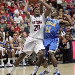 Arizona's Jordin Mayes (20) goes against the pressing defense of UCLA's Lazeric Jones (11) during the first half of an NCAA college basketball game at McKale Center in Tucson, Ariz., Thursday, Jan. 27, 2011. (AP Photo/John Miller)