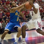 UCLA's Jerime Anderson, left, and Arizona's Kevin Parrom, right, struggle for control of the ball in the second half of an NCAA college basketball game at McKale Center in Tucson, Ariz., Thursday, Jan. 27, 2011. Arizona won 85-75. (AP Photo/Wily Low)