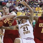 Arizona State's guard Keala King (21) takes a forearm to the face from Southern California's Alex Stepheson as Nikola Vucevic steals the ball during an NCAA college basketball game Thursday, Jan. 27, 2011, in Tempe, Ariz. (AP Photo/The Arizona Republic, Rob Schumacher)