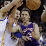 Phoenix Suns' Steve Nash, right, passes away from Golden State Warriors' Vladimir Radmanovic, left, and Stephen Curry during the first half of an NBA basketball game Monday, Feb. 7, 2011, in Oakland, Calif. (AP Photo/Ben Margot)