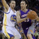 Phoenix Suns' Steve Nash, right, drives to the basket as Golden State Warriors' Stephen Curry defends during the first half of an NBA basketball game Monday, Feb. 7, 2011, in Oakland, Calif. (AP Photo/Ben Margot)