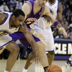 From left, Golden State Warriors' Reggie Williams, Phoenix Suns' Marcin Gortat, and Warriors' Ekpe Udoh chase a loose ball during the second half of an NBA basketball game Monday, Feb. 7, 2011, in Oakland, Calif. (AP Photo/Ben Margot)