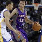 Phoenix Suns' Steve Nash, (13) keeps the ball from Golden State Warriors' Stephen Curry during the second half of an NBA basketball game Monday, Feb. 7, 2011, in Oakland, Calif. (AP Photo/Ben Margot)